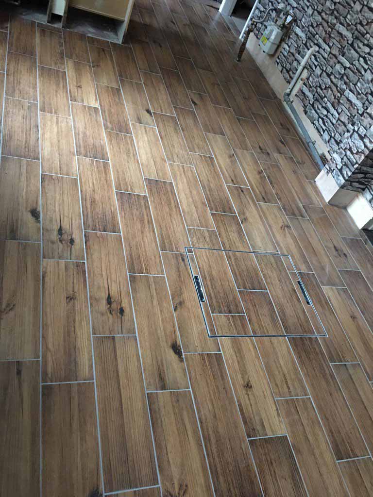 Wood effect floor tiles with drain tray in centre of floor