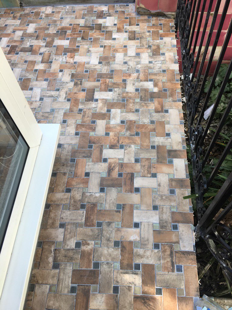 Patio are tiled with some hand made insert tiles