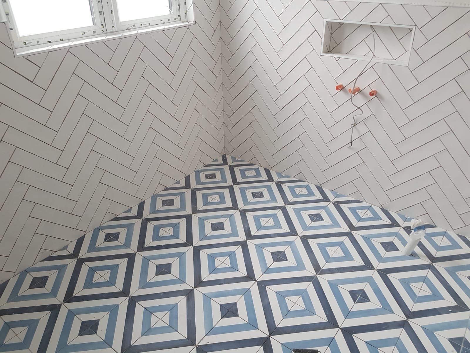Herringbone wall tiling with encaustic floor tiles