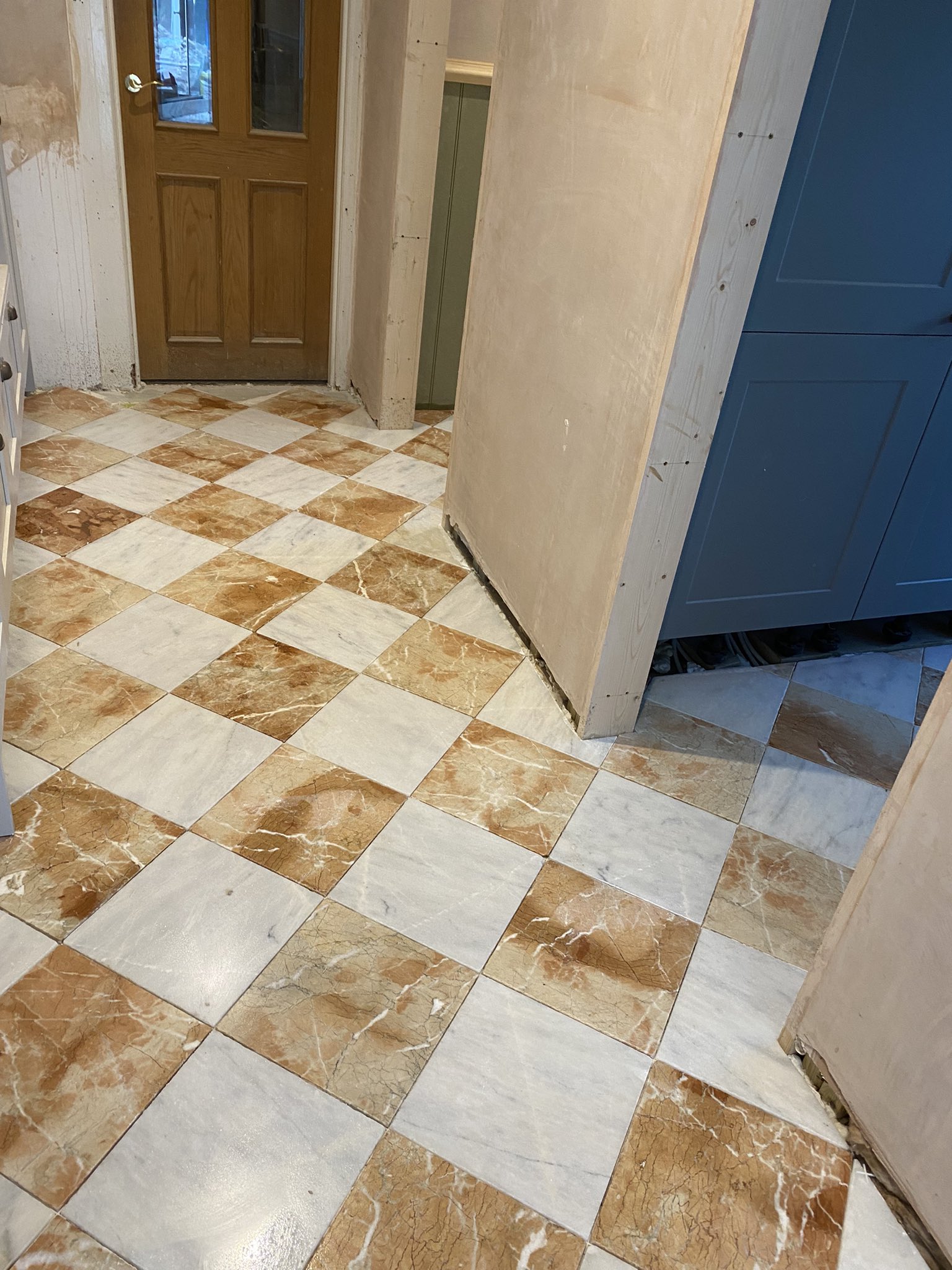 Marble hallway, utility floor and loo tiled in Hove